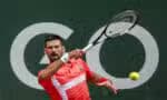 Serbia's Novak Djokovic returns a ball to Hungary's Marton Fucsovics during their match at the ATP 250 Geneva Open tennis tournament in Geneva on May 21, 2025. (Photo by FABRICE COFFRINI / AFP)